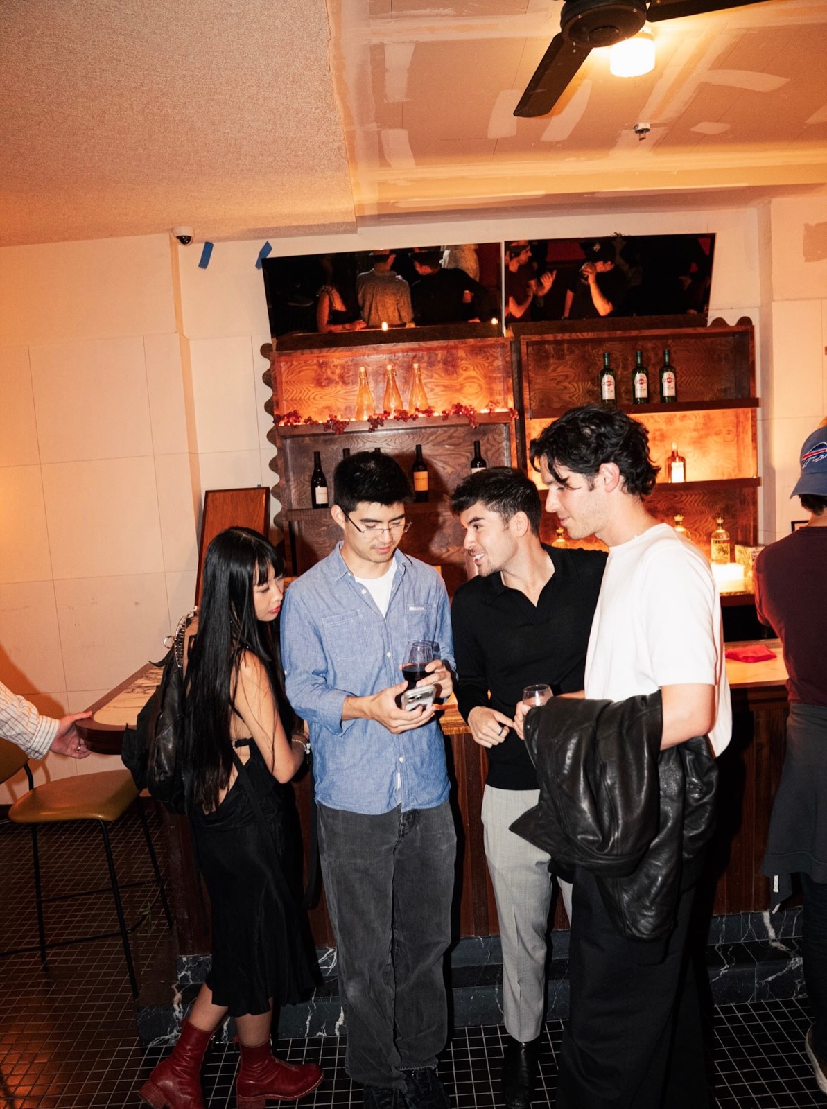 Guests standing and talking by the bar