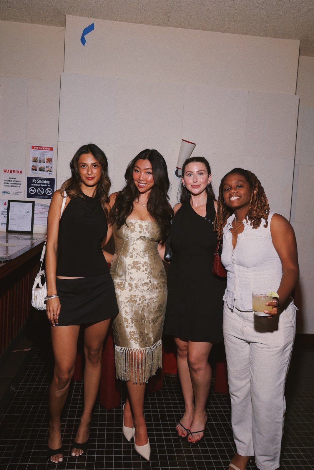 Four guests posing together at Menu x Ophelia