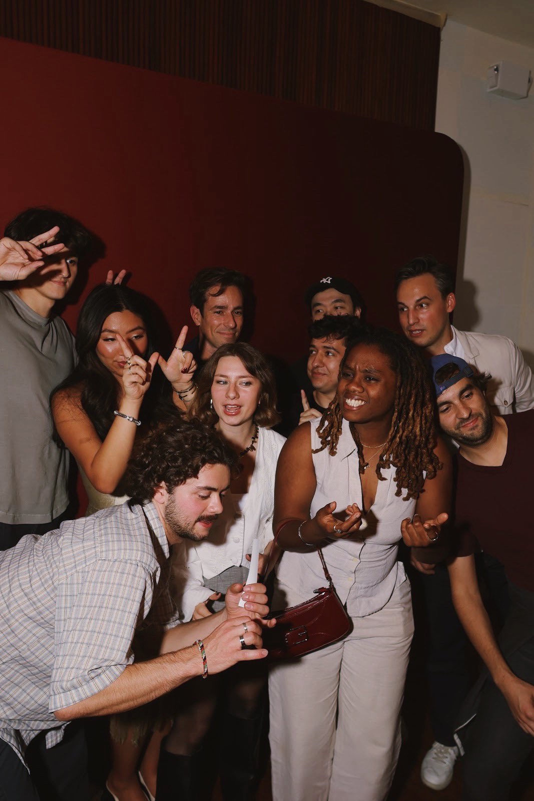 A group of guests throwing peace signs at the dinner