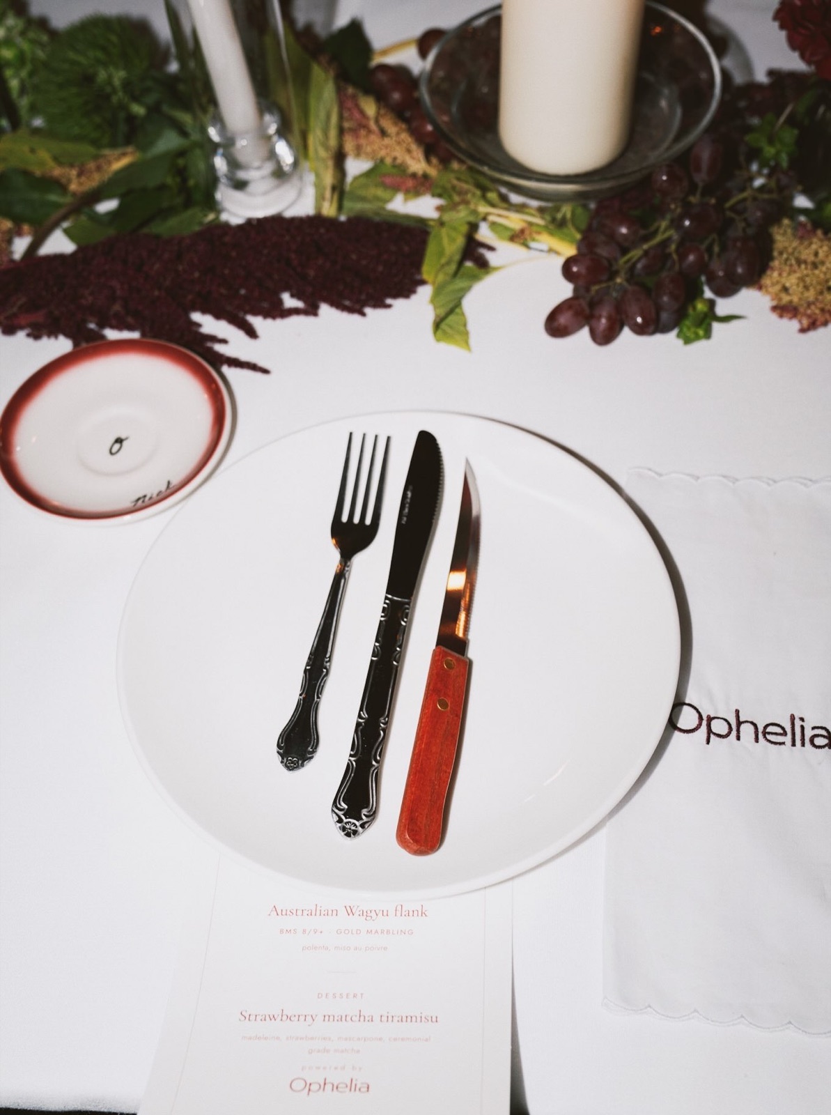 A place setting with an Ophelia menu card